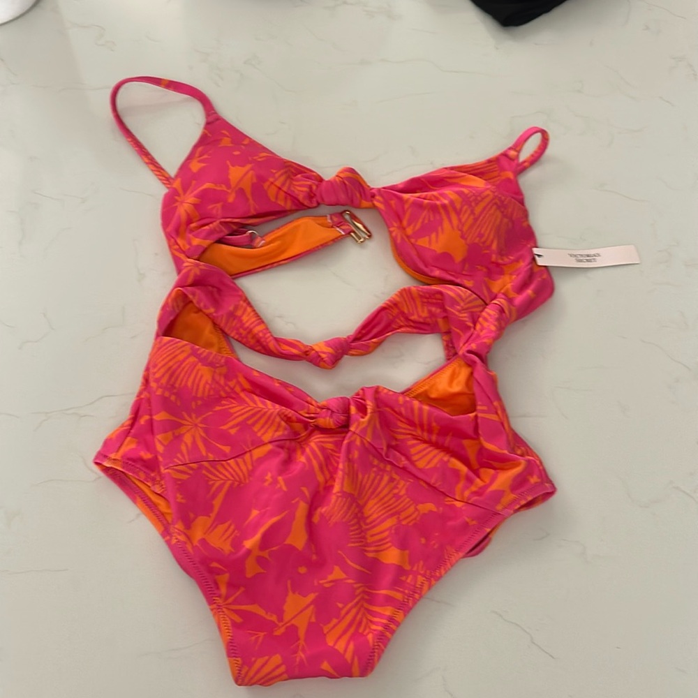 One piece with cutouts.  Pink with orange accents.